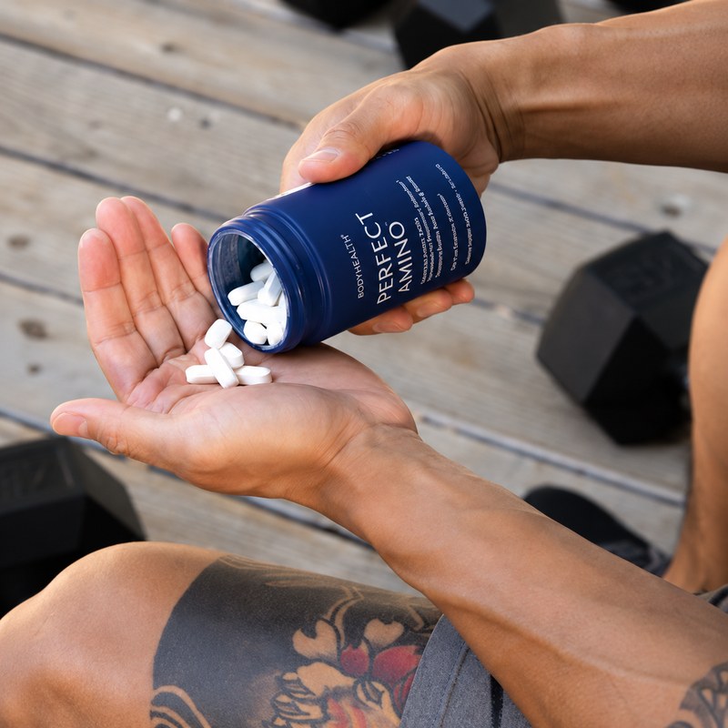 Pouring amino tablets into a hand